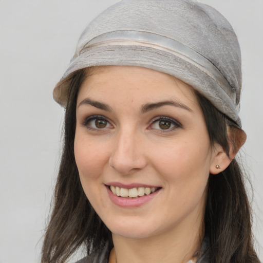 Joyful white young-adult female with long  brown hair and grey eyes