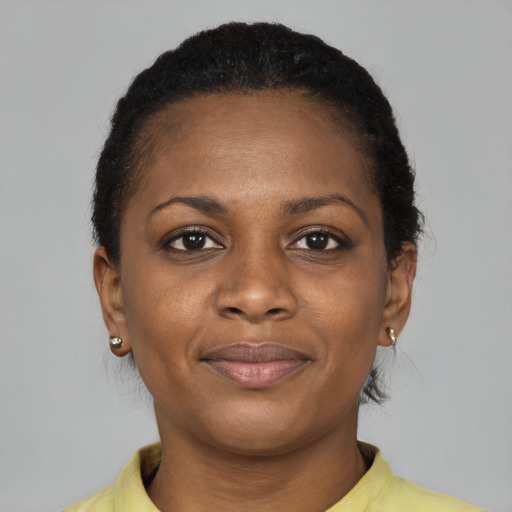 Joyful black young-adult female with short  brown hair and brown eyes