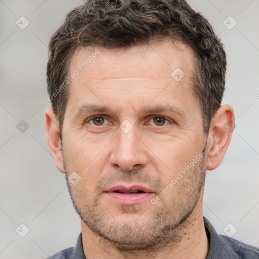 Joyful white adult male with short  brown hair and grey eyes