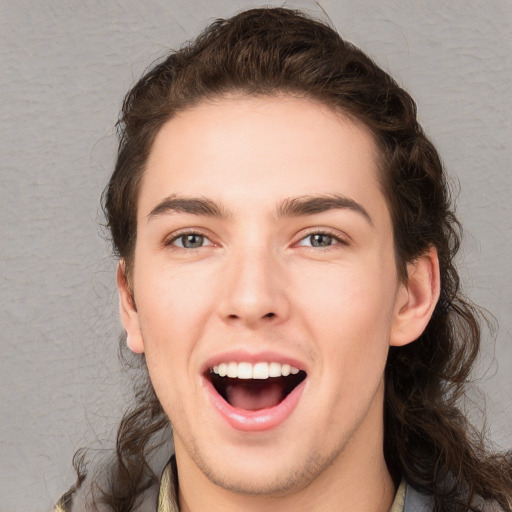 Joyful white young-adult male with medium  brown hair and brown eyes