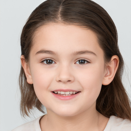 Joyful white child female with medium  brown hair and brown eyes