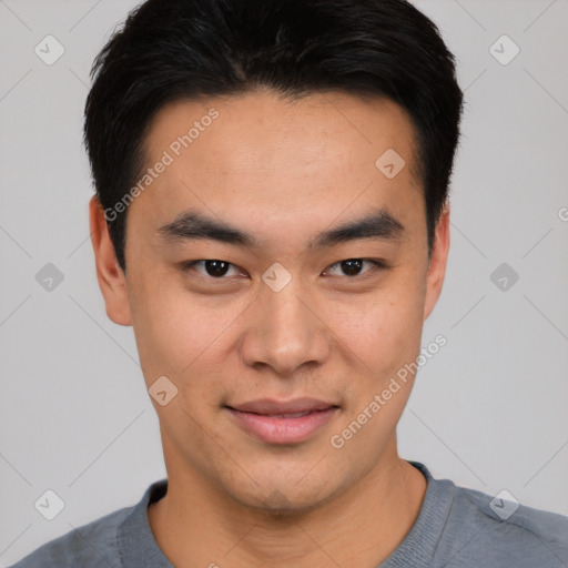 Joyful asian young-adult male with short  black hair and brown eyes