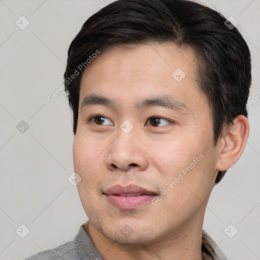 Joyful asian young-adult male with short  brown hair and brown eyes