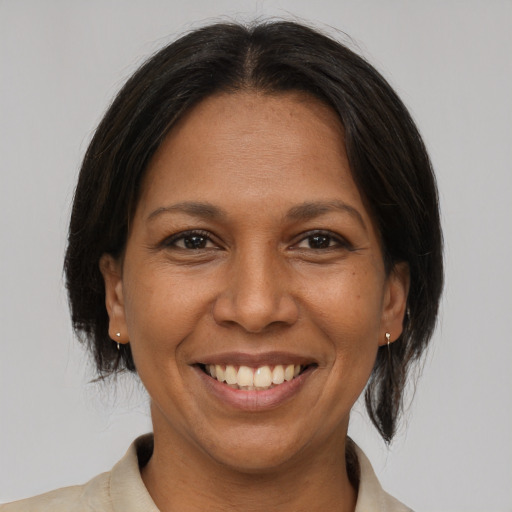 Joyful asian adult female with medium  brown hair and brown eyes