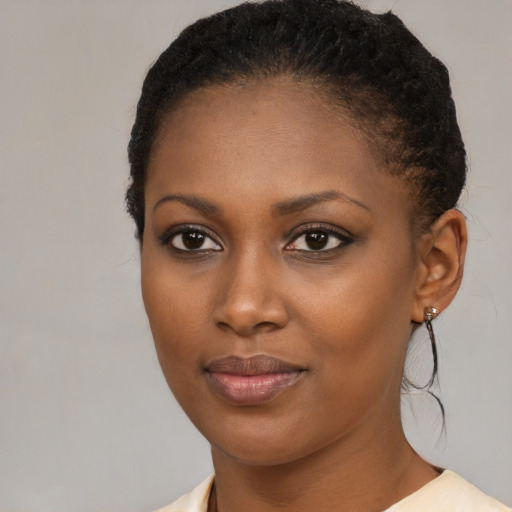 Joyful black young-adult female with short  brown hair and brown eyes