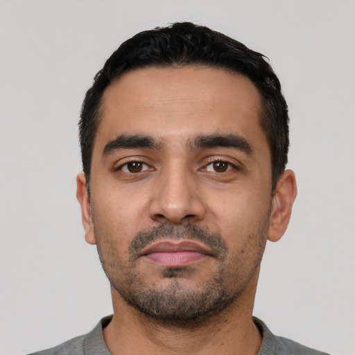 Neutral latino young-adult male with short  black hair and brown eyes