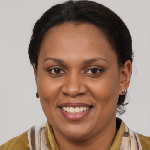 Joyful latino adult female with short  brown hair and brown eyes