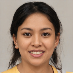 Joyful latino young-adult female with medium  brown hair and brown eyes