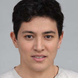 Joyful asian young-adult male with short  brown hair and brown eyes