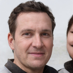 Joyful white adult male with short  brown hair and grey eyes