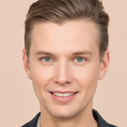 Joyful white young-adult male with short  brown hair and grey eyes