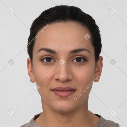 Joyful latino young-adult female with short  brown hair and brown eyes