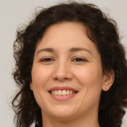 Joyful white adult female with medium  brown hair and brown eyes