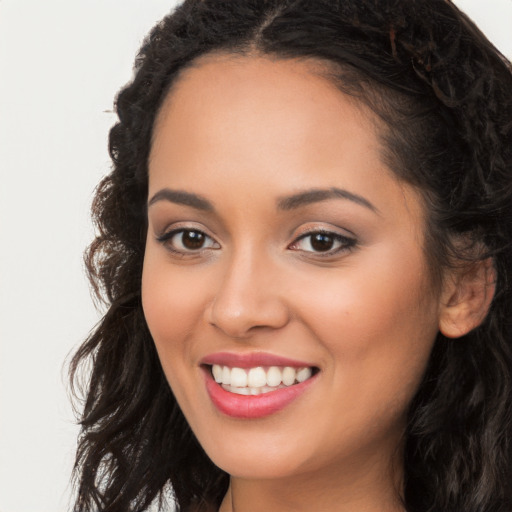 Joyful latino young-adult female with long  brown hair and brown eyes