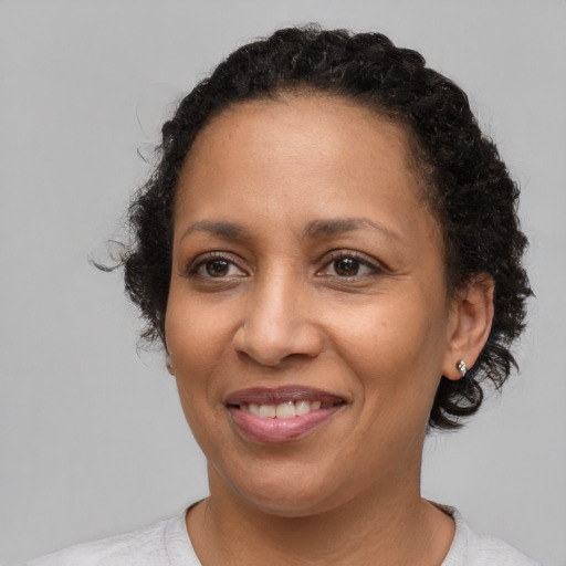 Joyful latino adult female with medium  brown hair and brown eyes