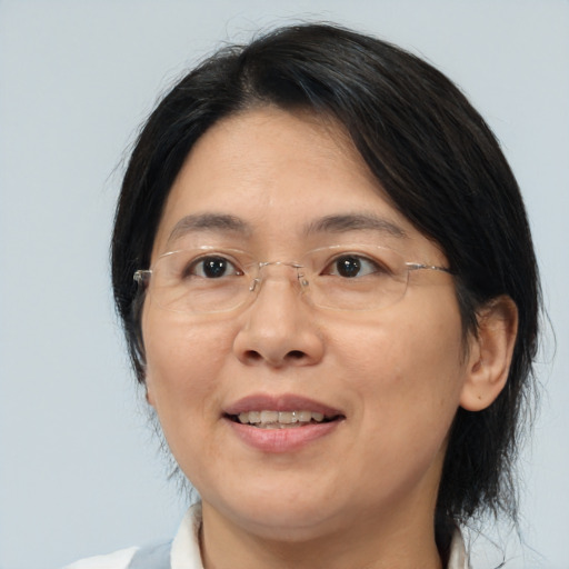 Joyful asian adult female with medium  brown hair and brown eyes