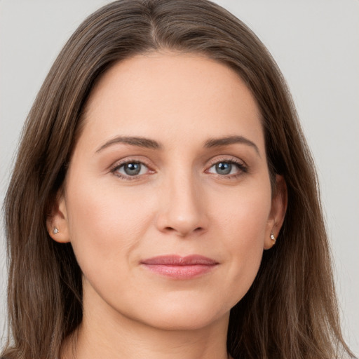 Joyful white young-adult female with long  brown hair and grey eyes