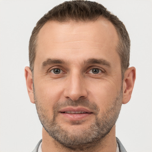 Joyful white adult male with short  brown hair and brown eyes