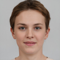 Joyful white young-adult female with short  brown hair and grey eyes