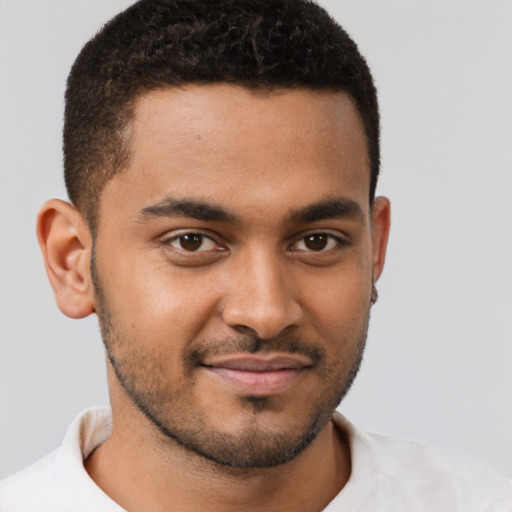 Joyful black young-adult male with short  brown hair and brown eyes