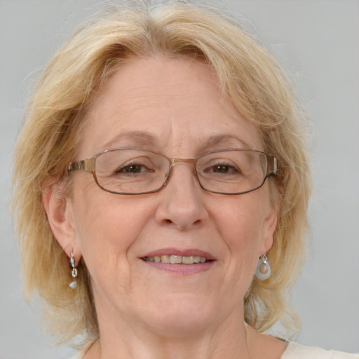 Joyful white middle-aged female with medium  blond hair and blue eyes