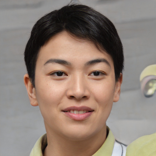 Joyful asian young-adult female with short  brown hair and brown eyes