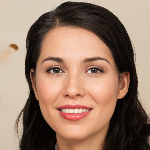 Joyful white young-adult female with long  brown hair and brown eyes