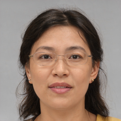 Joyful asian adult female with medium  brown hair and brown eyes