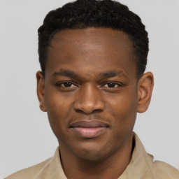 Joyful black young-adult male with short  brown hair and brown eyes