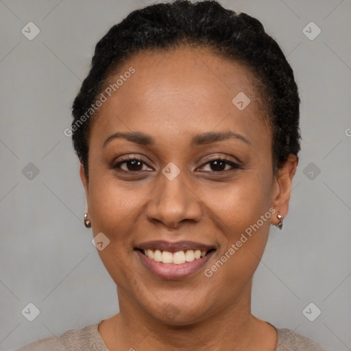 Joyful black adult female with short  black hair and brown eyes