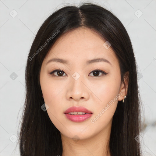 Joyful asian young-adult female with long  brown hair and brown eyes