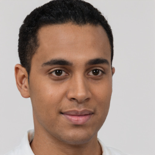 Joyful latino young-adult male with short  brown hair and brown eyes
