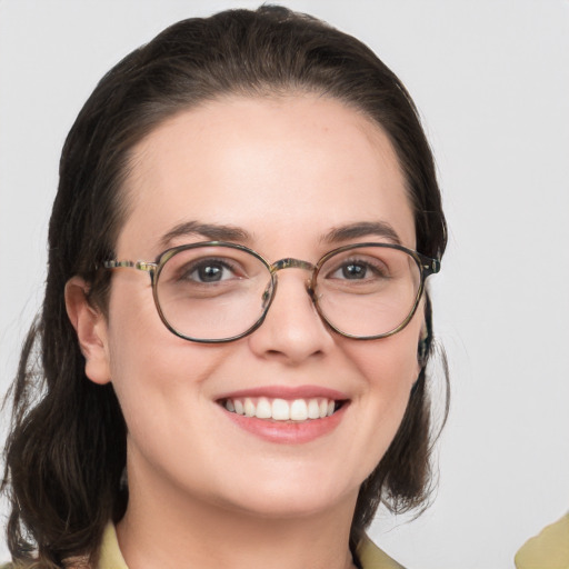 Joyful white young-adult female with medium  brown hair and green eyes