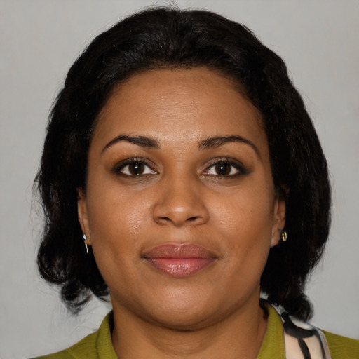 Joyful black young-adult female with medium  black hair and brown eyes