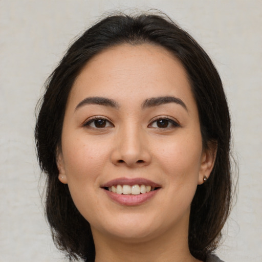 Joyful asian young-adult female with medium  brown hair and brown eyes