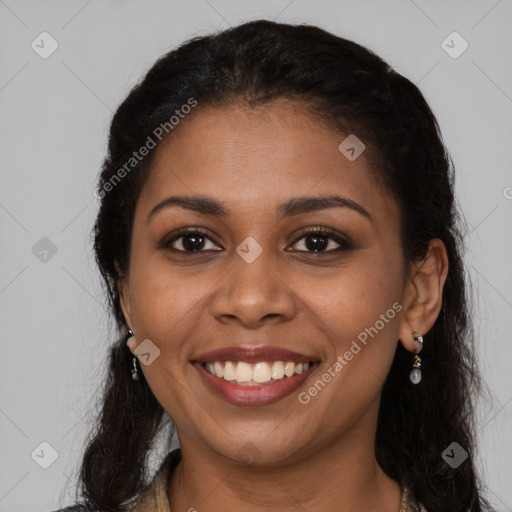 Joyful black young-adult female with long  black hair and brown eyes