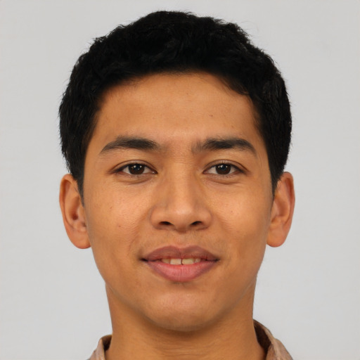 Joyful asian young-adult male with short  black hair and brown eyes