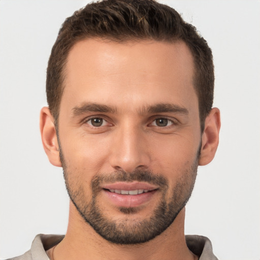 Joyful white young-adult male with short  brown hair and brown eyes