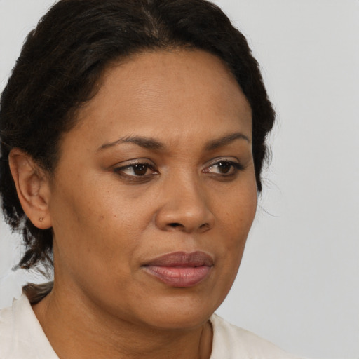 Joyful black adult female with short  brown hair and brown eyes