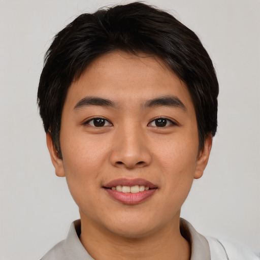 Joyful asian young-adult male with short  brown hair and brown eyes