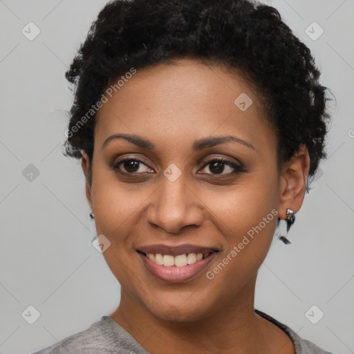 Joyful black young-adult female with short  black hair and brown eyes