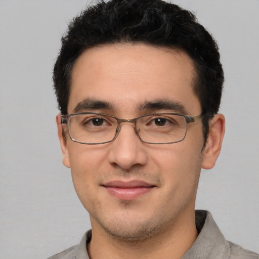 Joyful white young-adult male with short  black hair and brown eyes