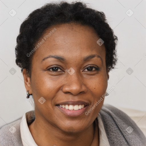 Joyful black adult female with short  brown hair and brown eyes