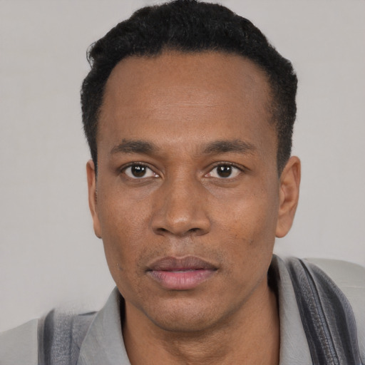 Neutral black adult male with short  black hair and brown eyes
