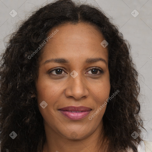 Joyful black young-adult female with long  brown hair and brown eyes