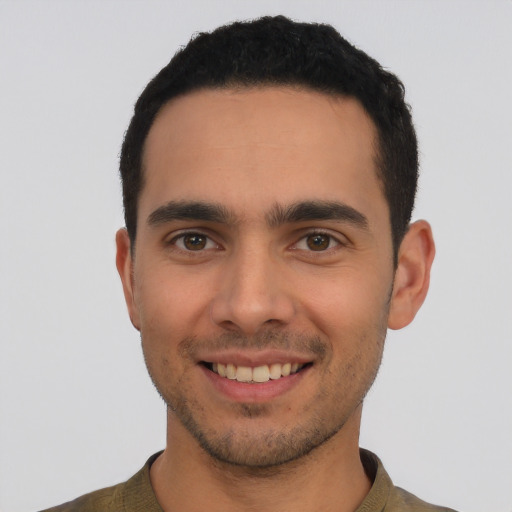 Joyful white young-adult male with short  black hair and brown eyes