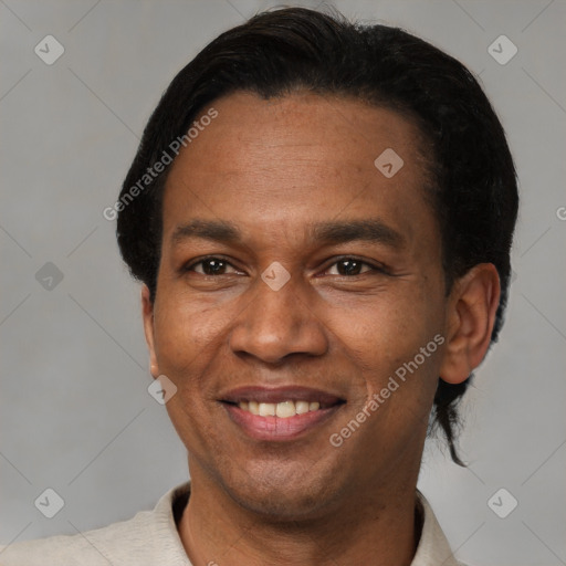 Joyful latino adult male with short  black hair and brown eyes