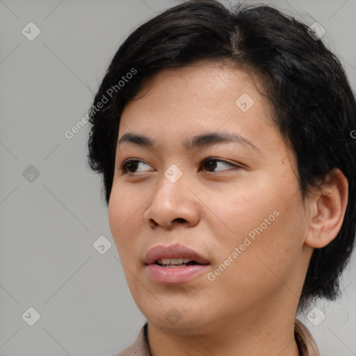 Joyful asian young-adult female with medium  black hair and brown eyes