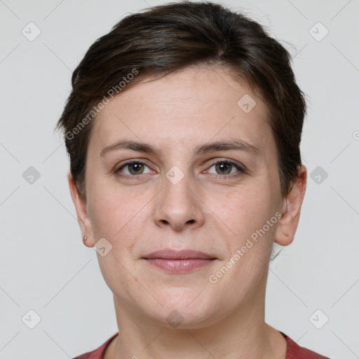 Joyful white young-adult female with short  brown hair and grey eyes