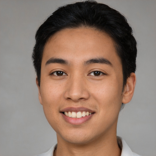 Joyful latino young-adult male with short  black hair and brown eyes